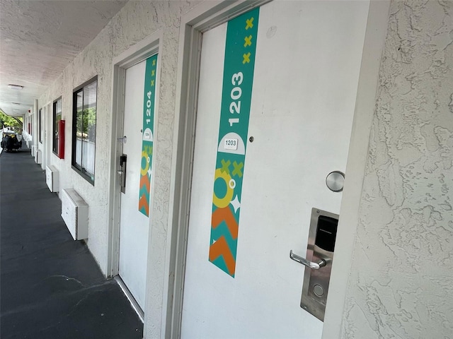 property entrance featuring stucco siding