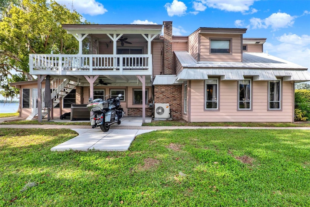 12228 Kirby Smith Rd, Orlando, FL 32832 - view of front of property with a patio, stairway, a ceiling fan, and a front yard