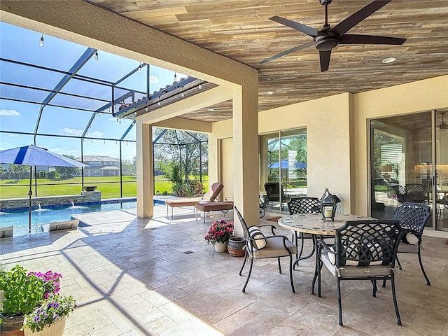 view of patio featuring outdoor dining area, a lanai, an outdoor pool, and a ceiling fan