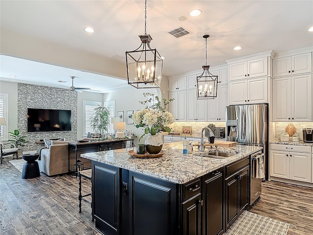 kitchen featuring ceiling fan with notable chandelier, dark wood finished floors, visible vents, recessed lighting, and a sink