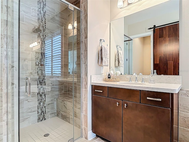 full bath with a stall shower and vanity