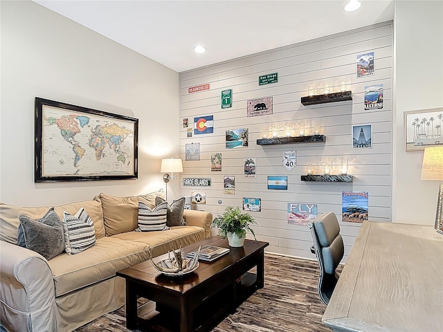 living room featuring wood finished floors, wooden walls, and recessed lighting