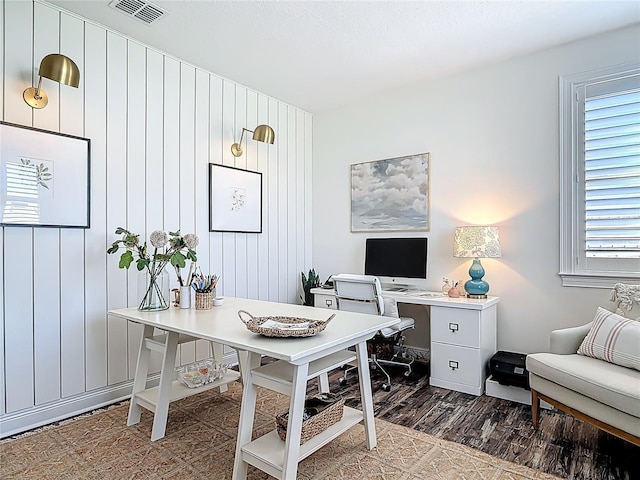 office space featuring wood finished floors and visible vents