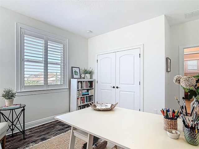 office space with dark wood-style floors and visible vents
