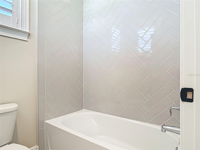 bathroom featuring toilet and shower / bath combination