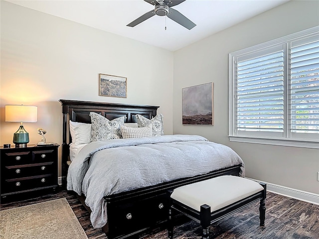 bedroom with dark wood-type flooring, ceiling fan, and baseboards