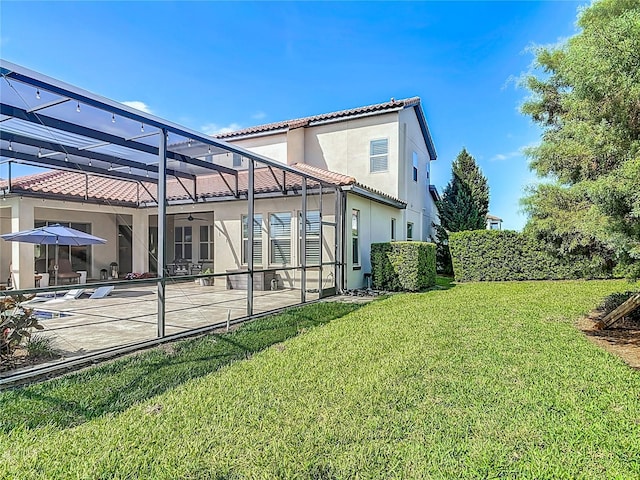 exterior space with a patio area, a tile roof, glass enclosure, and stucco siding