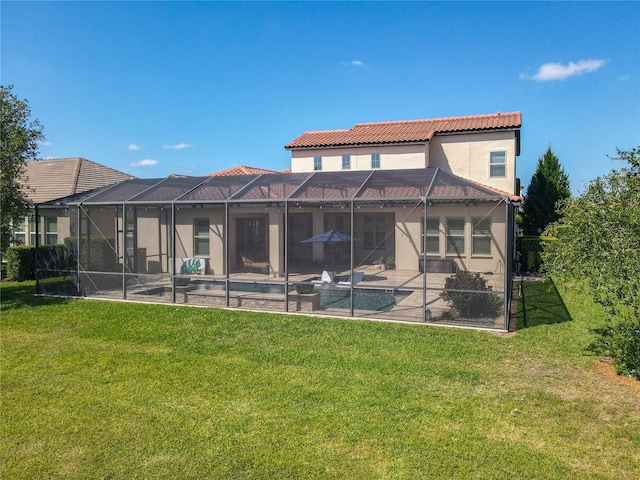 rear view of property featuring stucco siding, an outdoor pool, a patio area, a tile roof, and a lawn