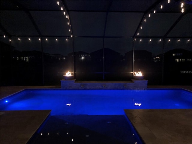 view of pool at night