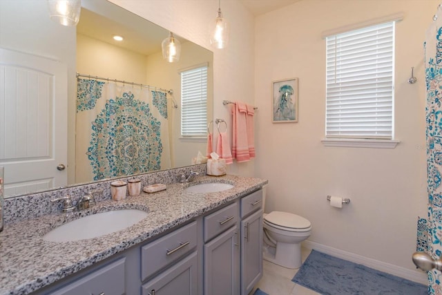 6960 Audobon Osprey Cv, Harmony, FL 34773 - full bathroom featuring double vanity, baseboards, a sink, and toilet