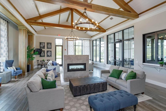 6960 Audobon Osprey Cv, Harmony, FL 34773 - living room featuring visible vents, baseboards, an inviting chandelier, a fireplace, and wood finished floors