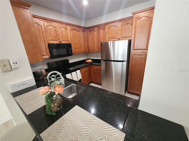 2528 Robert Trent Jones Dr Unit 1617, Orlando, FL 32835 - kitchen featuring brown cabinetry, a sink, and black appliances