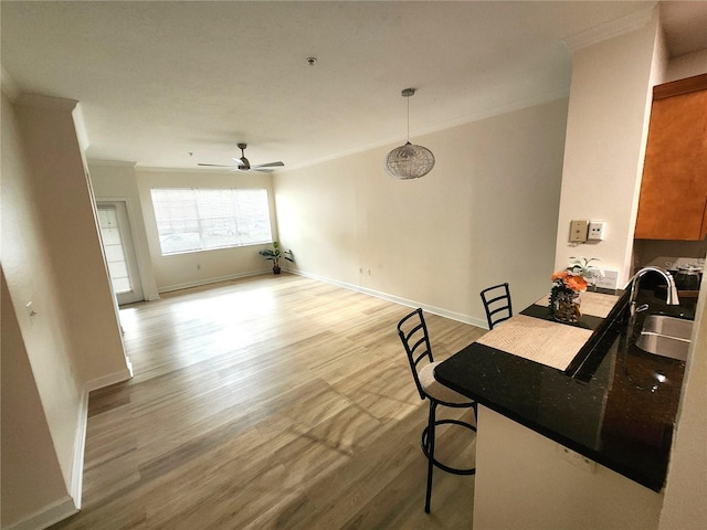2528 Robert Trent Jones Dr Unit 1617, Orlando, FL 32835 - dining area featuring baseboards, crown molding, a ceiling fan, and wood finished floors