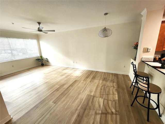2528 Robert Trent Jones Dr Unit 1617, Orlando, FL 32835 - unfurnished dining area with baseboards, wood finished floors, crown molding, and ceiling fan