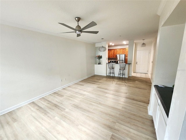 2528 Robert Trent Jones Dr Unit 1617, Orlando, FL 32835 - unfurnished living room featuring ornamental molding, light wood-type flooring, a ceiling fan, and baseboards
