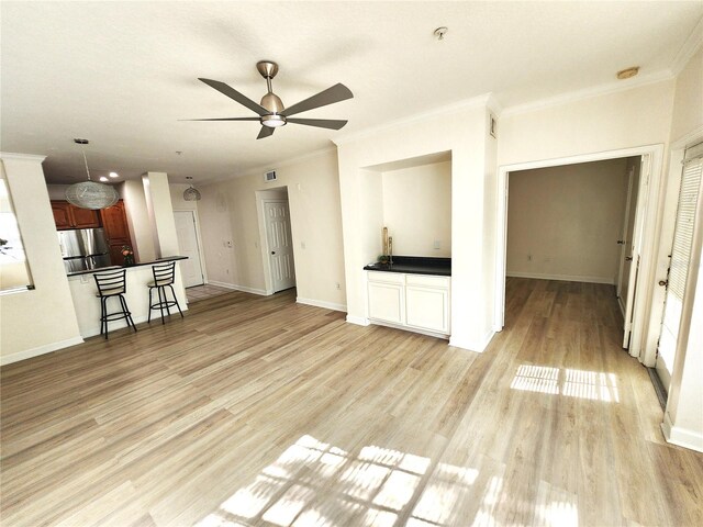 2528 Robert Trent Jones Dr Unit 1617, Orlando, FL 32835 - unfurnished living room with light wood-style flooring, ornamental molding, ceiling fan, and baseboards