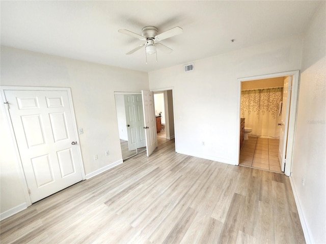 2528 Robert Trent Jones Dr Unit 1617, Orlando, FL 32835 - unfurnished bedroom featuring baseboards, light wood-style flooring, ensuite bathroom, a ceiling fan, and visible vents