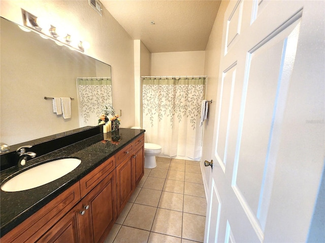 2528 Robert Trent Jones Dr Unit 1617, Orlando, FL 32835 - bathroom featuring vanity, tile patterned floors, a shower with curtain, toilet, and visible vents