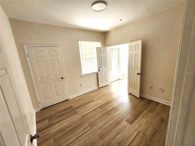2528 Robert Trent Jones Dr Unit 1617, Orlando, FL 32835 - unfurnished bedroom featuring baseboards and wood finished floors