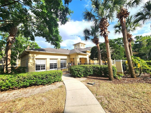 2528 Robert Trent Jones Dr Unit 1617, Orlando, FL 32835 - view of front of house with stucco siding and a fenced front yard