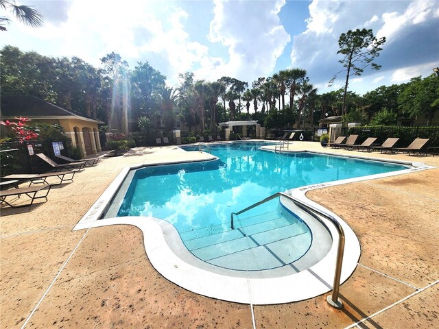 2528 Robert Trent Jones Dr Unit 1617, Orlando, FL 32835 - community pool with fence and a patio