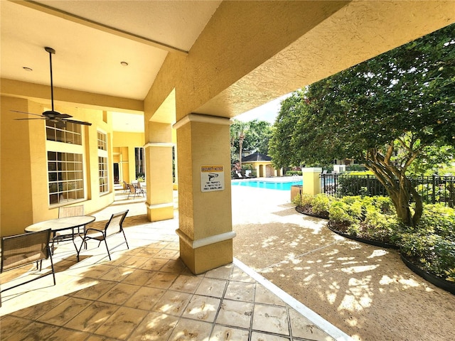 2528 Robert Trent Jones Dr Unit 1617, Orlando, FL 32835 - view of patio with a community pool and fence