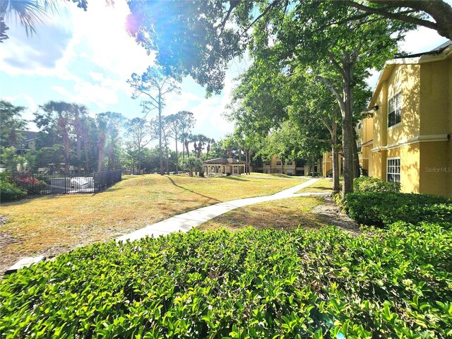 2528 Robert Trent Jones Dr Unit 1617, Orlando, FL 32835 - view of property's community featuring a yard and fence