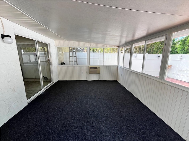 unfurnished sunroom with a wall mounted AC