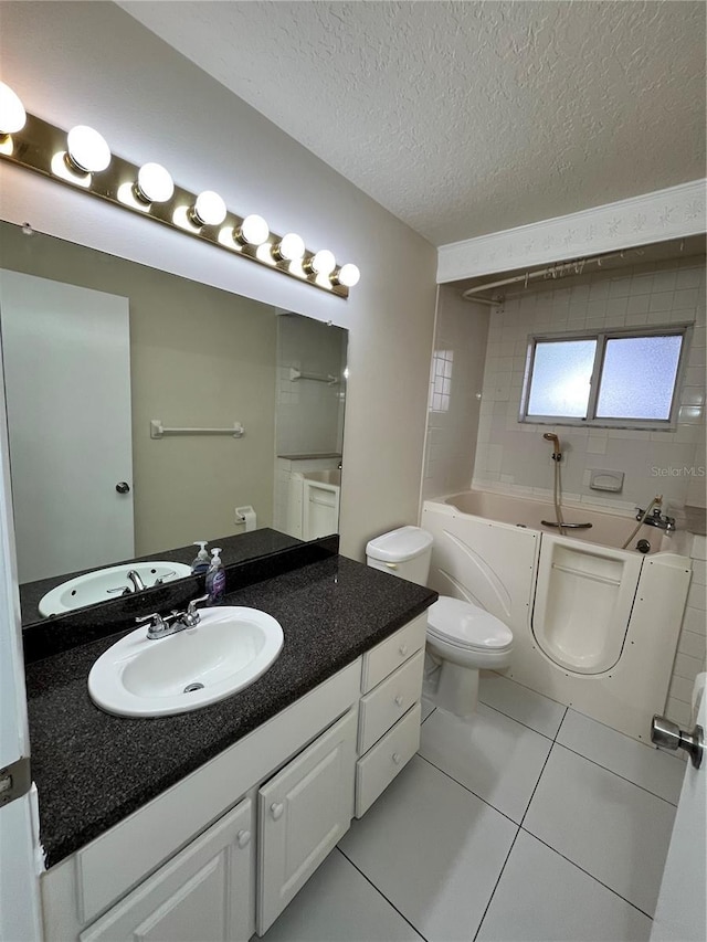 full bath featuring a washtub, a textured ceiling, tile patterned floors, vanity, and toilet