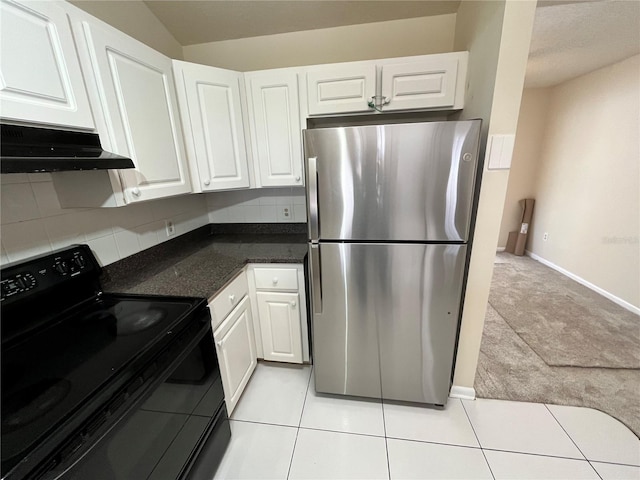 kitchen with freestanding refrigerator, white cabinetry, under cabinet range hood, and black range with electric stovetop