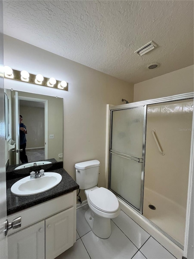 full bathroom featuring visible vents, tile patterned floors, a textured ceiling, and a stall shower