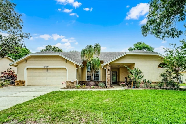 single story home featuring concrete driveway, stucco siding, a front lawn, brick siding, and a garage
