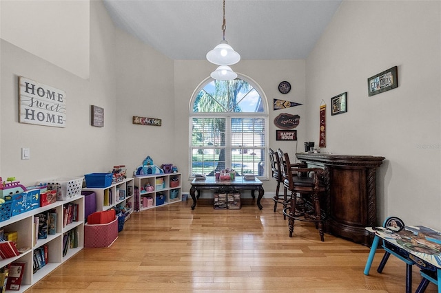 game room with baseboards and wood finished floors