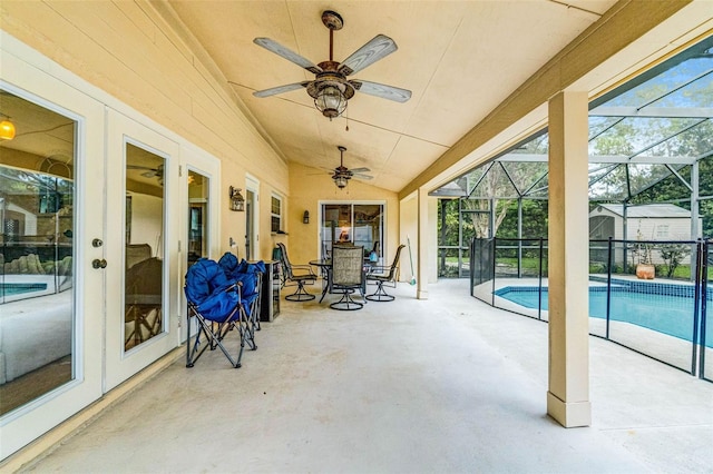 view of patio / terrace featuring a lanai, an outdoor pool, and a ceiling fan