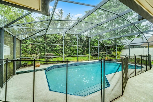 view of pool with a patio, a fenced in pool, and glass enclosure