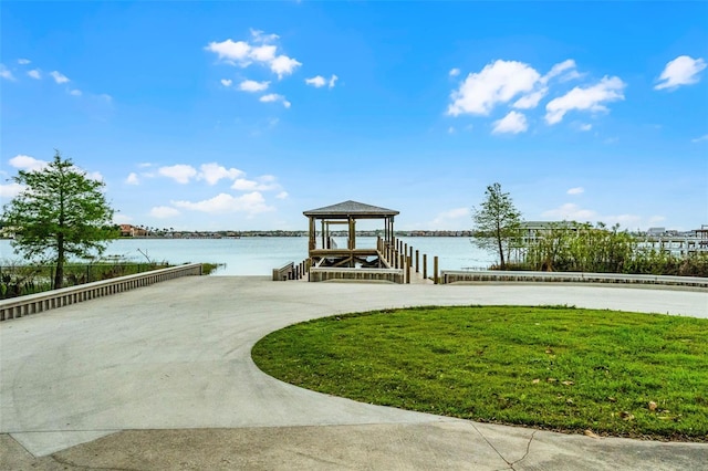 dock area featuring a water view and a lawn