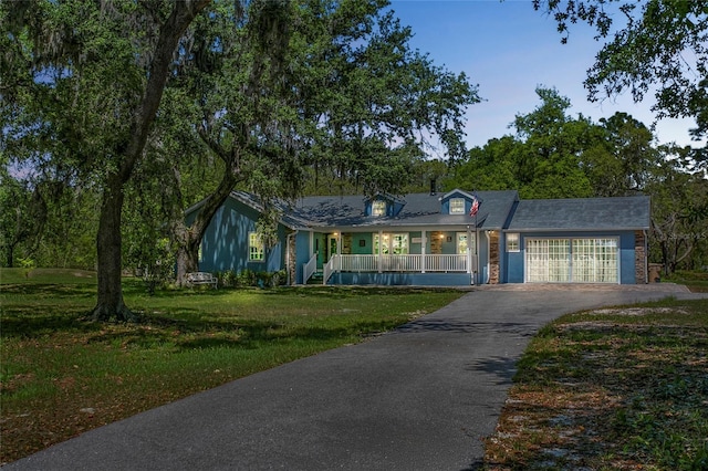 6330 Oil Well Rd, Clermont, FL 34714 - view of front of home featuring a porch, driveway, a front yard, and a garage