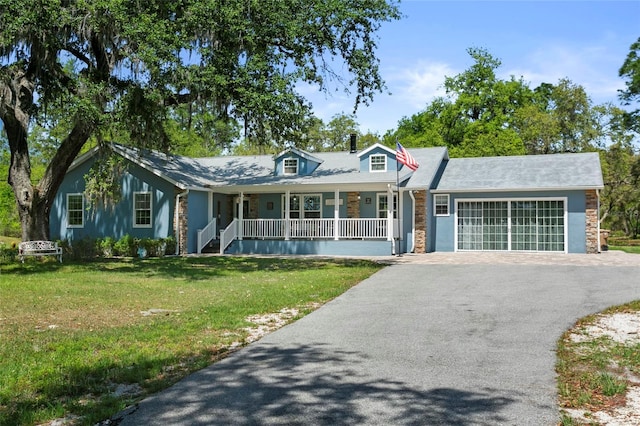 6330 Oil Well Rd, Clermont, FL 34714 - view of front of property with a front yard, a porch, an attached garage, and aphalt driveway