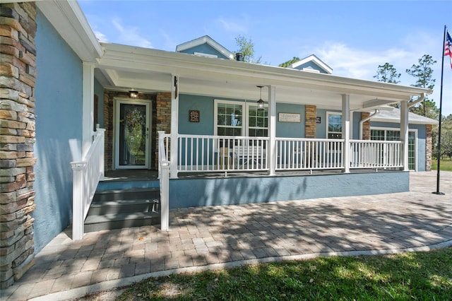 6330 Oil Well Rd, Clermont, FL 34714 - property entrance with stucco siding, stone siding, and covered porch