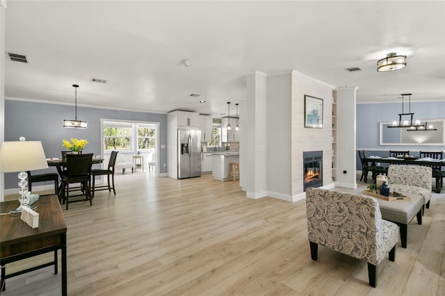 6330 Oil Well Rd, Clermont, FL 34714 - living area with a notable chandelier, a large fireplace, and visible vents