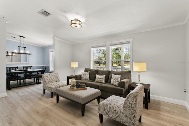 6330 Oil Well Rd, Clermont, FL 34714 - living room with a chandelier, light wood finished floors, baseboards, and ornamental molding