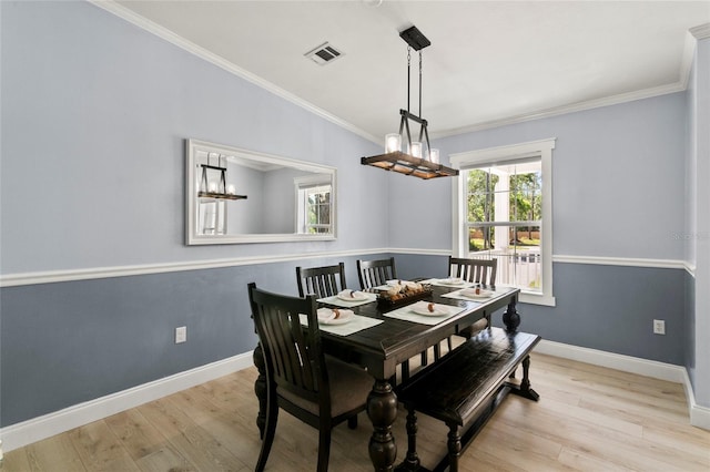 6330 Oil Well Rd, Clermont, FL 34714 - dining room featuring visible vents, baseboards, crown molding, and wood finished floors