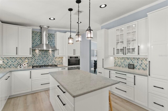 6330 Oil Well Rd, Clermont, FL 34714 - kitchen with appliances with stainless steel finishes, wall chimney range hood, backsplash, and a kitchen island