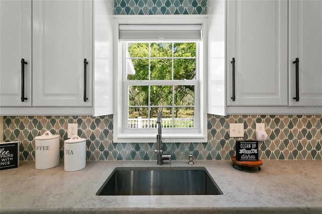 6330 Oil Well Rd, Clermont, FL 34714 - kitchen featuring a sink, tasteful backsplash, white cabinetry, and light stone counters