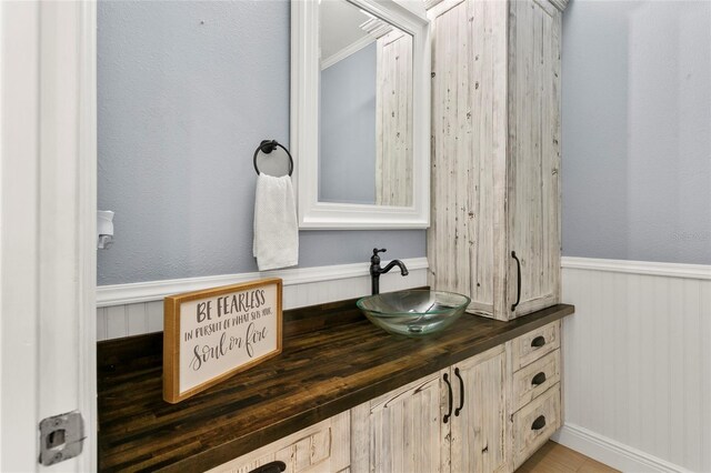6330 Oil Well Rd, Clermont, FL 34714 - interior details with crown molding, vanity, and a wainscoted wall