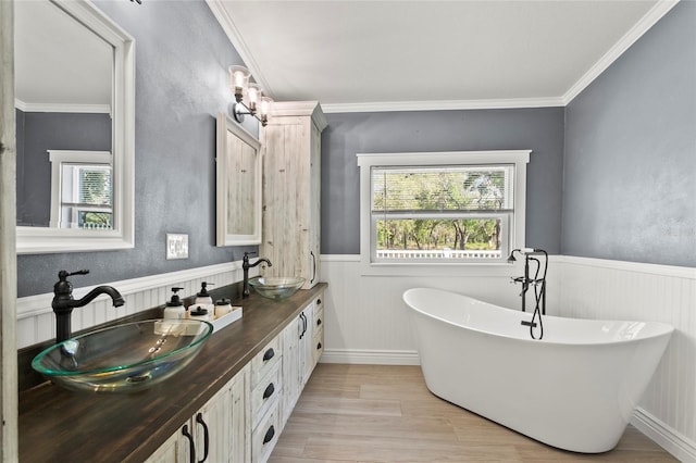 6330 Oil Well Rd, Clermont, FL 34714 - full bathroom featuring wood finished floors, a sink, wainscoting, and a freestanding tub