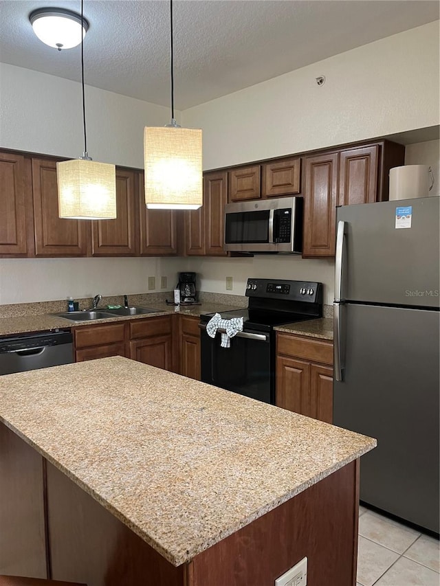 12527 Floridays Resort Dr Unit 311E, Orlando, FL 32821 - kitchen with decorative light fixtures, a sink, appliances with stainless steel finishes, light stone countertops, and light tile patterned flooring
