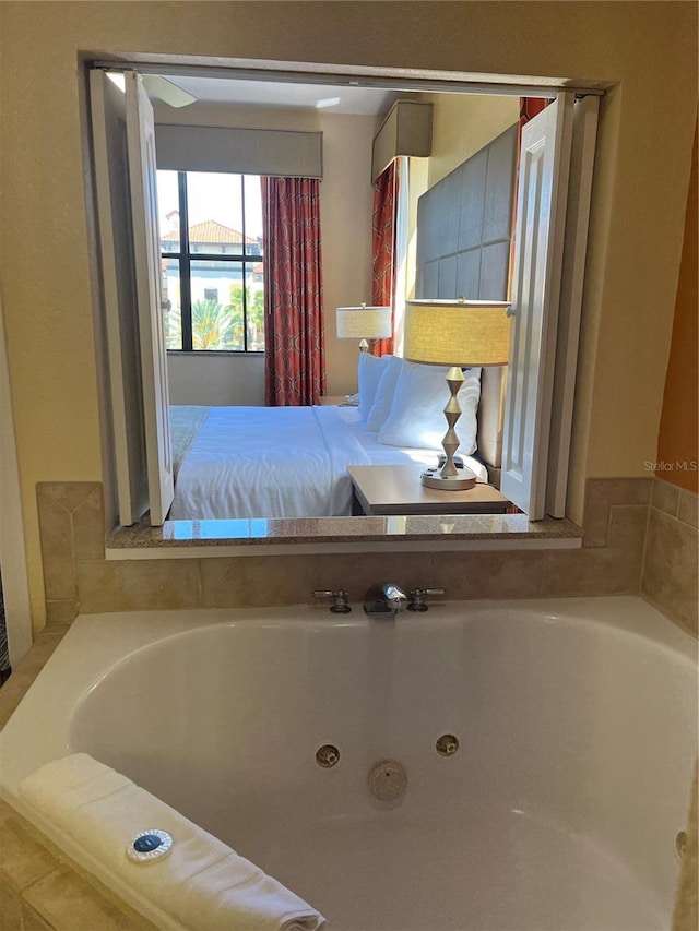 12527 Floridays Resort Dr Unit 311E, Orlando, FL 32821 - bathroom featuring a tub with jets
