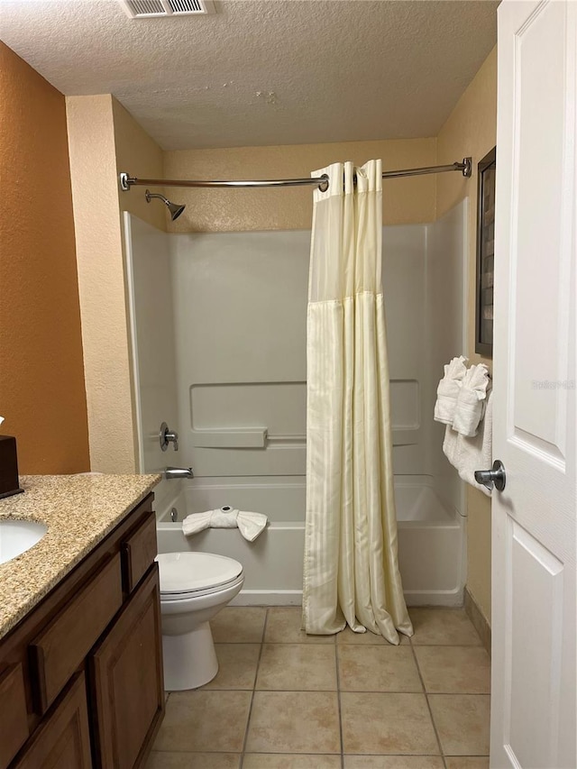 12527 Floridays Resort Dr Unit 311E, Orlando, FL 32821 - full bath featuring shower / bath combo, toilet, a textured ceiling, vanity, and tile patterned flooring