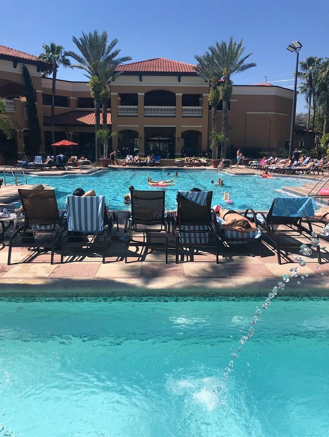 12527 Floridays Resort Dr Unit 311E, Orlando, FL 32821 - community pool featuring a patio